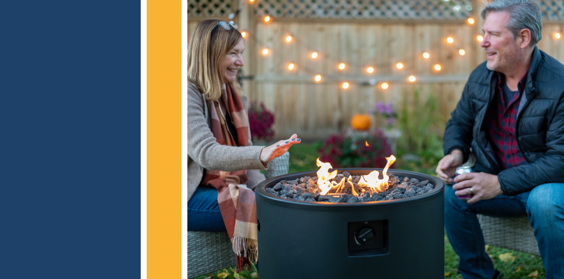 middle age couple sitting by a backyard fire pit in autumn